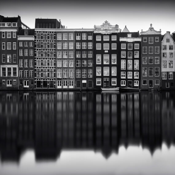 Amsterdam old houses reflecting the water canals