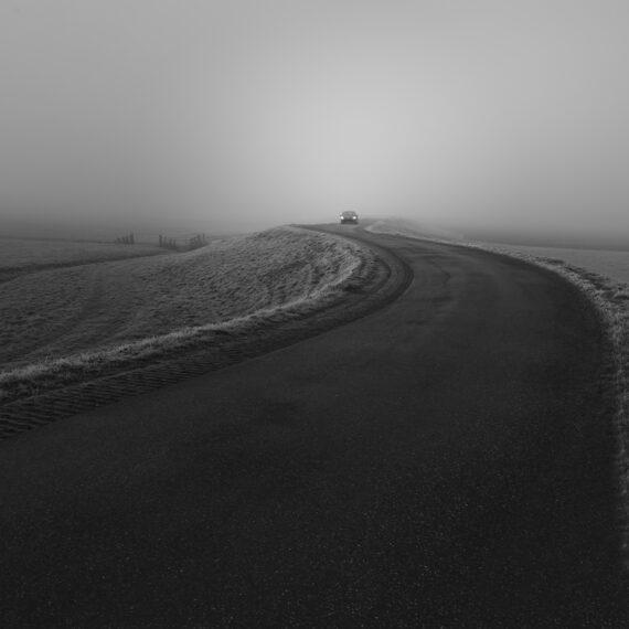 Car in the fog on a twisty road