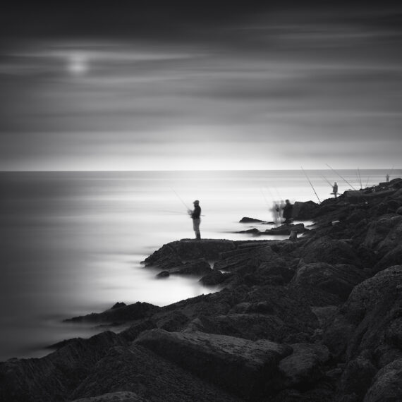 Fishing man on the beach in the moon light