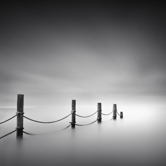 Poles with ropes in between in the water of the IJsselmeer