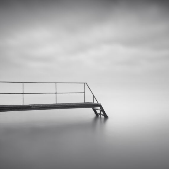 metal jetty with stair in the water