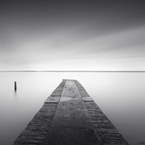 wood jetty in the water with pole markermeer