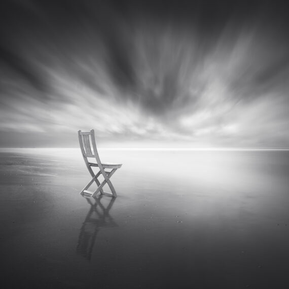 White Bistro Chair on the beach at Wijk aan Zee with long exposure
