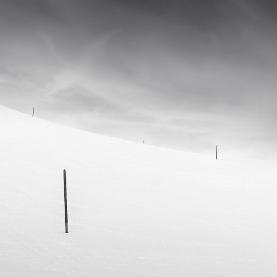 Three poles in the snow creating a minimalism image