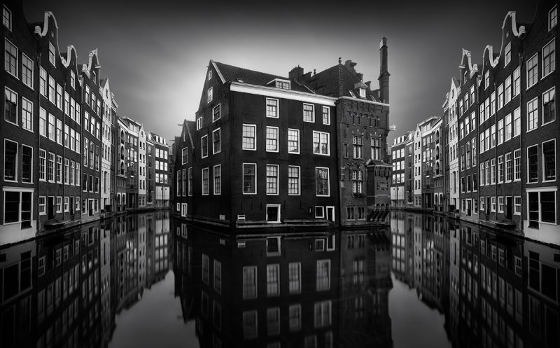 Canal houses in Amsterdam reflecting in the water